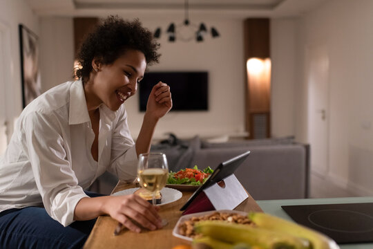 Happy African American lady speaking with boyfriend online