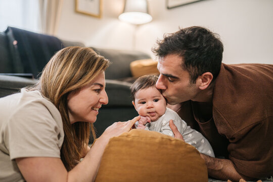 Parents bonding with baby at home, sharing love