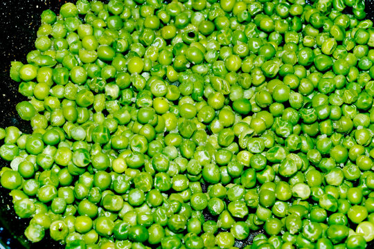 green peas cooking in a pan on the stove
