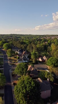 4K vertical hyper lapse video of flying over upscale american suburbs