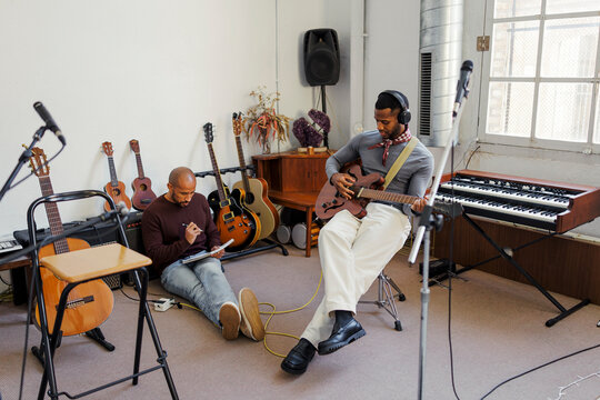 Musicians collaborating on new song in recording studio