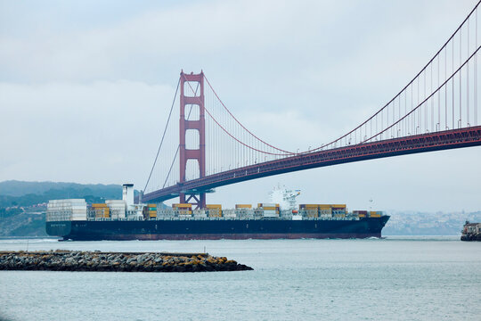 The ship sails under the Golden Gate Bridge