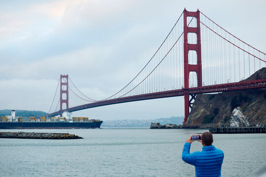 Man photographs the Golden Gate Bridge.
