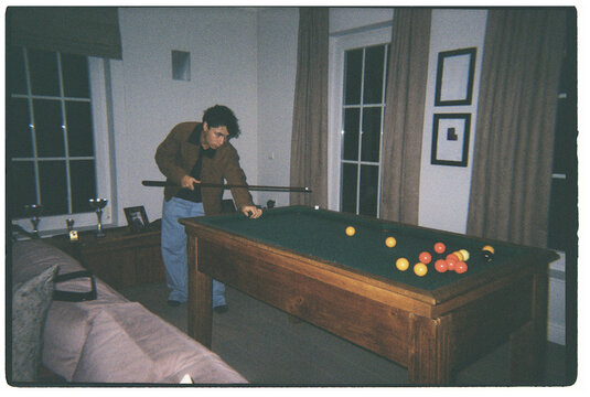 Playing Pool in a Cozy Room During Evening Hours With Friends