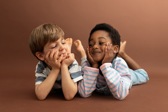 Diverse boys smiling connecting in childhood friendship
