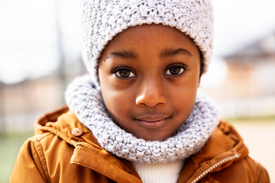 African american child wearing winter knit hat and scarf