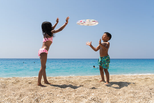 Children Playing Together by the Sea in Summer