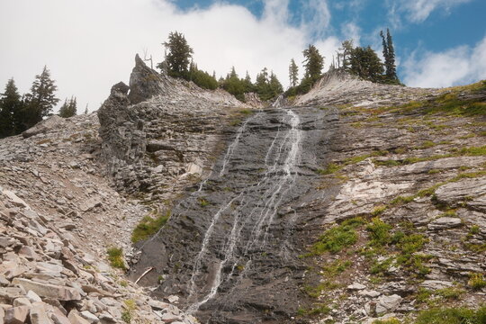 Water Flows Down Rocky Terrain in a Mountainous Region