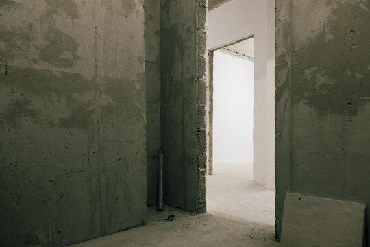 Indoor Space With Concrete Walls and Open Doorways in Vacant Area