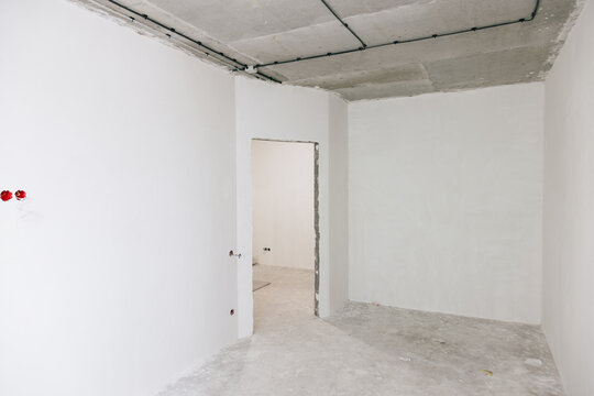 Empty Room With Bare Walls and Doorway Ready for Design