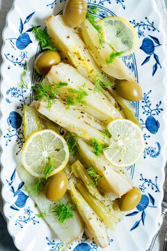 Close-up of braised leeks with olives and lemon