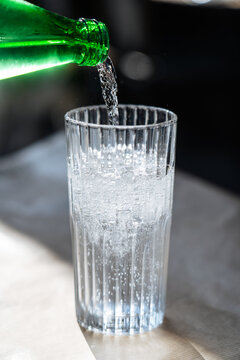 Sparkling water pouring into clear glass