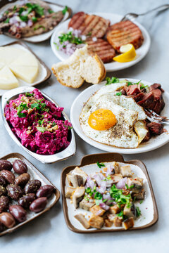 Assorted Greek appetizers with egg, salad, olives, and meat