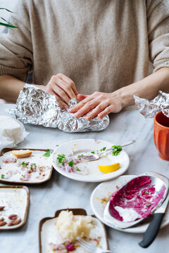 Wrapping leftovers in foil after a meal