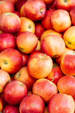 Red and yellow apples stacked together