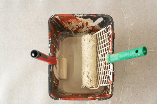 Renovation work with paint roller tray and tools