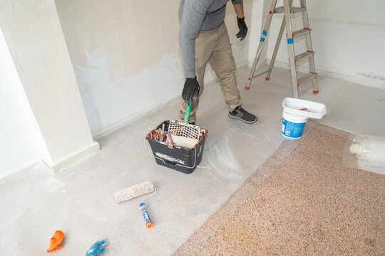 Man painting wall during home renovation project