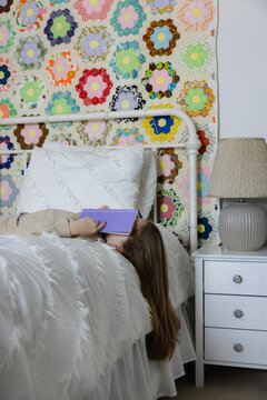 Girl bored with reading on her bed