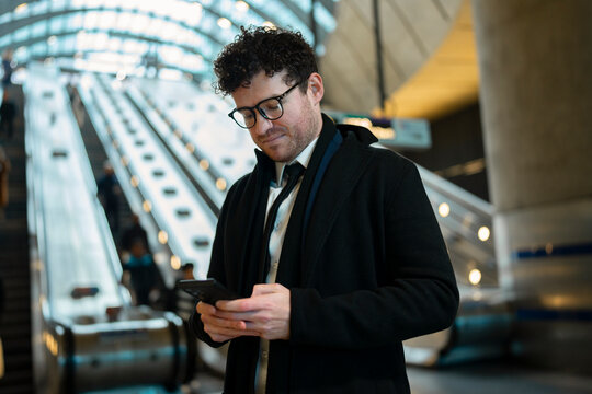 A man stands inside a train station
