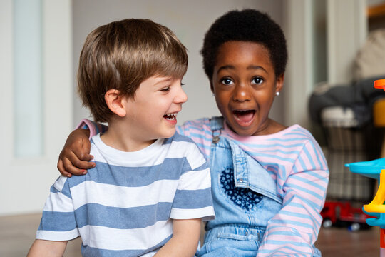 Diverse children laughing and showing surprise expressing friendship