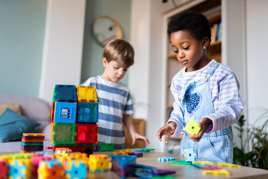 Children playing with colorful magnetic building blocks