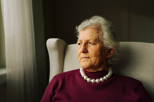 Portrait of a senior woman looking out of window