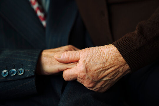 Holding hands of senior couple 