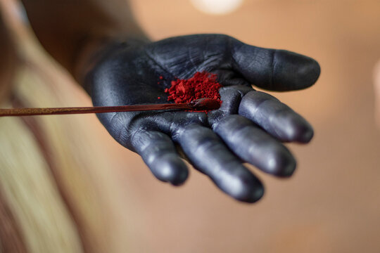 Indigenous woman's hand with pigments for ancestral makeup