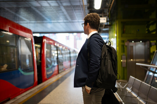 Man waits for train at station
