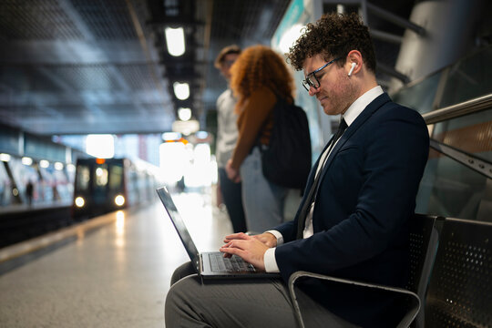 Working on Laptop at Metro Station