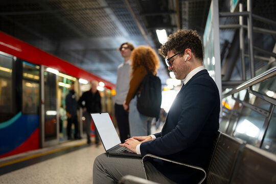 Working on Laptop at Metro Station