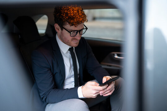 Businessman using smartphone while commuting