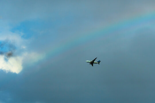A commercial airplane on the background of the rainbow 