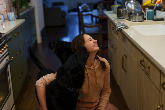 Woman with the dog on the kitchen 