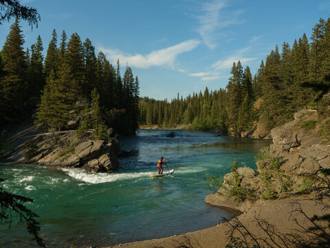 Man on a SUP on wild river in Canada 