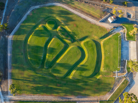 Shadows falling over an aquatic race track of green channels and bends