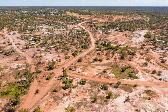Dirt tracks winding through rustic building in an arid outback camp