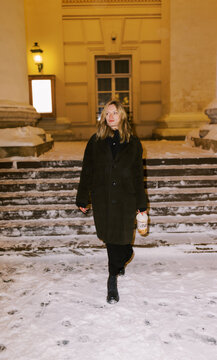 Walk on Snowy Steps at Night Near a Building in Winter