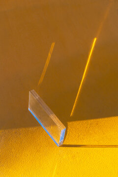 Glass Prism Refracting Sunlight on Yellow Wall and Floor