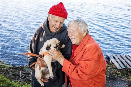 Elderly couple and dog by the water