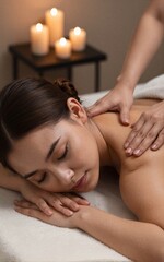 Fototapeta premium Woman relaxes in spa receiving back massage under soft candlelight