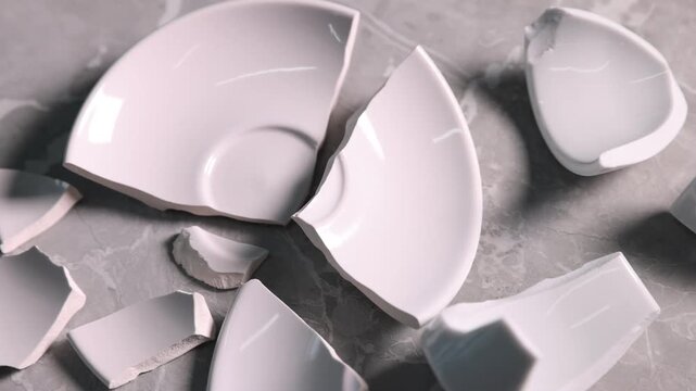 Pieces of broken saucer and cup on light grey table, closeup. Camera moving forward
