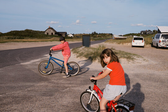 kids biking on vacation in denmark by the coast