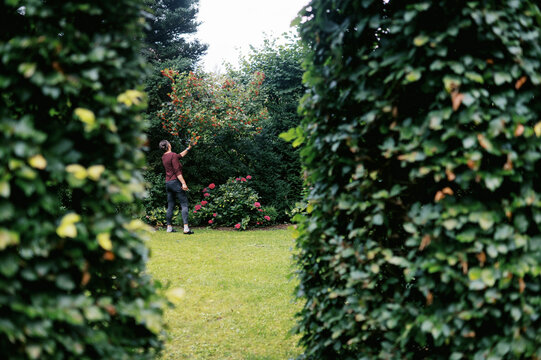 woman walking through mature garden in germany