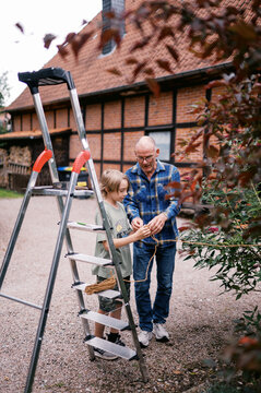 grandfather and grandchild working together in garden