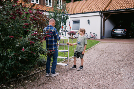 grandfather and grandchild working together in garden