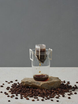 Freshly Brewed Coffee Using a Drip Filter Over Transparent Glass