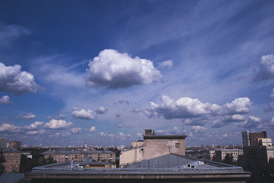 View of City Buildings and Sky With Clouds on a Clear Day