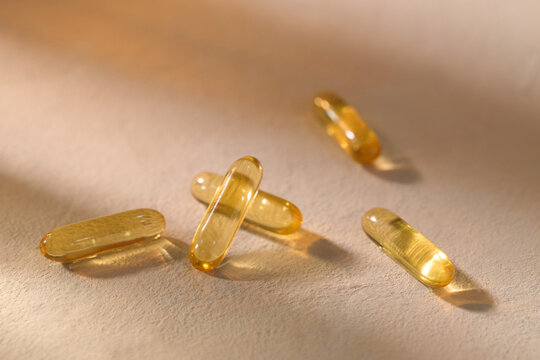 Close-up of yellow softgel capsules, offering a natural approach