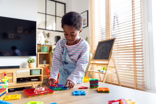 Little african american girl building with colorful blocks
